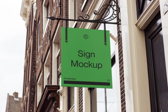 Green hanging sign mockup with elegant iron brackets on a classic building background, perfect for branding presentations by designers.